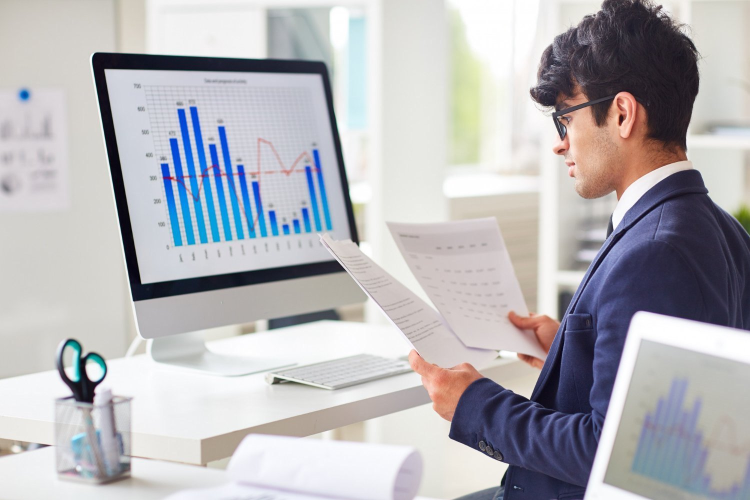 Professional reviewing business analytics and data visualisations